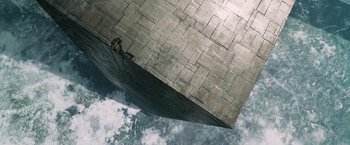 Movie still from “The Hitchhiker's Guide to the Galaxy” (2005), directed by Garth Jennings – An aerial view of a building with a sky in the background; Extreme Wide shot, Overhead angle