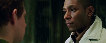 Movie still from “The Hitchhiker's Guide to the Galaxy” (2005), directed by Garth Jennings – A man's face in front of a green background; Close Up shot, Low angle