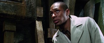 Movie still from “The Hitchhiker's Guide to the Galaxy” (2005), directed by Garth Jennings – A man in white shirt and tie looking to his left; Close Up shot, Low angle