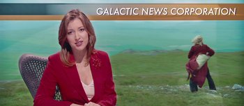 Movie still from “The Hitchhiker's Guide to the Galaxy” (2005), directed by Garth Jennings – A woman wearing a red jacket in front of a green field; Medium shot, Over the shoulder angle