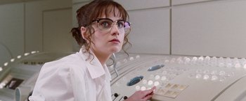 Movie still from “The Hitchhiker's Guide to the Galaxy” (2005), directed by Garth Jennings – A woman in glasses is sitting in front of a computer keyboard; Close Up shot, Over the shoulder angle