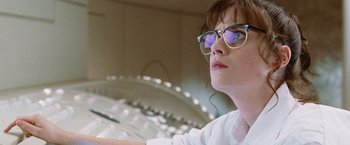 Movie still from “The Hitchhiker's Guide to the Galaxy” (2005), directed by Garth Jennings – A woman wearing glasses and a white shirt looking up; Close Up shot, Low angle
