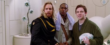 Movie still from “The Hitchhiker's Guide to the Galaxy” (2005), directed by Garth Jennings – A group of men standing next to each other; Medium shot, Over the shoulder angle