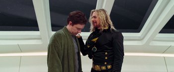 Movie still from “The Hitchhiker's Guide to the Galaxy” (2005), directed by Garth Jennings – Two men standing next to each other and one has his hand on the other's face; Medium shot, Over the shoulder angle