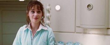 Movie still from “The Hitchhiker's Guide to the Galaxy” (2005), directed by Garth Jennings – A woman standing in front of a white wall; Close Up shot, Over the shoulder angle