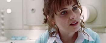 Movie still from “The Hitchhiker's Guide to the Galaxy” (2005), directed by Garth Jennings – A person wearing a blue sweater; Close Up shot, Over the shoulder angle