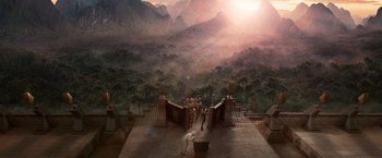 Movie still from “The Hitchhiker's Guide to the Galaxy” (2005), directed by Garth Jennings – A group of people standing on top of a building near trees; Extreme Wide shot, High angle