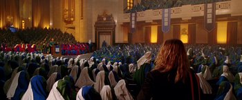 Movie still from “The Hitchhiker's Guide to the Galaxy” (2005), directed by Garth Jennings – A group of people sitting in a large auditorium; Extreme Wide shot, High angle