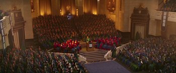 Movie still from “The Hitchhiker's Guide to the Galaxy” (2005), directed by Garth Jennings – A large group of people sitting in a large auditorium; Extreme Wide shot, High angle