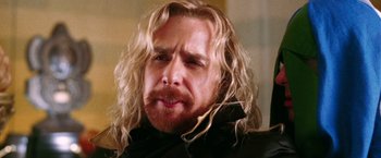 Movie still from “The Hitchhiker's Guide to the Galaxy” (2005), directed by Garth Jennings – A person with long blonde hair; Close Up shot, Over the shoulder angle