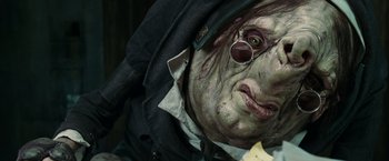 Movie still from “The Hitchhiker's Guide to the Galaxy” (2005), directed by Garth Jennings – A person's face in a costume; Close Up shot, Low angle