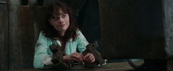 Movie still from “The Hitchhiker's Guide to the Galaxy” (2005), directed by Garth Jennings – A woman is holding a pair of rusty wrenches in her hands; Close Up shot, High angle