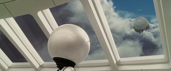 Movie still from “The Hitchhiker's Guide to the Galaxy” (2005), directed by Garth Jennings – A white ball is in front of a cloudy sky; Close Up shot, Low angle