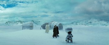 Movie still from “The Hitchhiker's Guide to the Galaxy” (2005), directed by Garth Jennings – A group of people standing on top of a snow covered ground; Extreme Wide shot, Over the shoulder angle