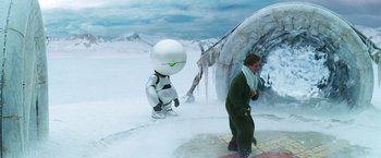Movie still from “The Hitchhiker's Guide to the Galaxy” (2005), directed by Garth Jennings – A man standing next to an alien in a snowy area; Wide shot, Over the shoulder angle