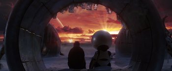 Movie still from “The Hitchhiker's Guide to the Galaxy” (2005), directed by Garth Jennings – Two people sitting in front of an orange sky at sunset; Wide shot, Low angle