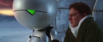Movie still from “The Hitchhiker's Guide to the Galaxy” (2005), directed by Garth Jennings – A man is looking at a robot with a green face; Close Up shot, Over the shoulder angle