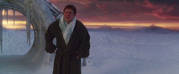 Movie still from “The Hitchhiker's Guide to the Galaxy” (2005), directed by Garth Jennings – A man in a robe and a scarf standing in the snow with mountains in the background; Medium shot, Low angle