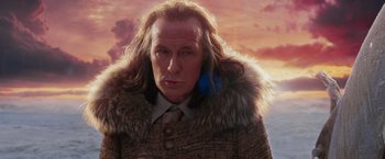 Movie still from “The Hitchhiker's Guide to the Galaxy” (2005), directed by Garth Jennings – A man with long hair wearing a fur coat and a tie; Close Up shot, Low angle
