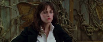 Movie still from “The Hitchhiker's Guide to the Galaxy” (2005), directed by Garth Jennings – A woman in a white shirt and black jacket looking sad; Close Up shot, Over the shoulder angle