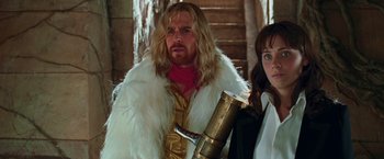 Movie still from “The Hitchhiker's Guide to the Galaxy” (2005), directed by Garth Jennings – A man with a long blonde hair and a beard; Medium shot, Low angle