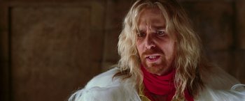Movie still from “The Hitchhiker's Guide to the Galaxy” (2005), directed by Garth Jennings – A person with long blonde hair; Close Up shot, Over the shoulder angle