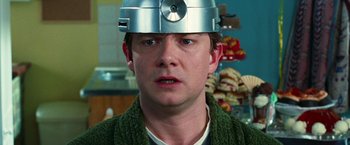 Movie still from “The Hitchhiker's Guide to the Galaxy” (2005), directed by Garth Jennings – A man wearing a metal helmet in a kitchen; Close Up shot, Low angle