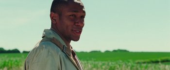 Movie still from “The Hitchhiker's Guide to the Galaxy” (2005), directed by Garth Jennings – A man standing in front of a green field; Close Up shot, Low angle