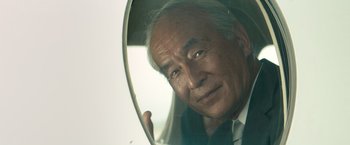 Movie still from “The Hitman's Bodyguard” (2017), directed by Patrick Hughes – An older man looking at himself in a mirror; Close Up shot, Low angle
