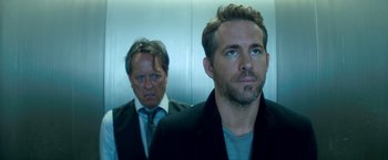 Movie still from “The Hitman's Bodyguard” (2017), directed by Patrick Hughes – Two men standing next to each other in front of a wall; Close Up shot, Low angle
