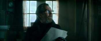 Movie still from “The Hitman's Bodyguard” (2017), directed by Patrick Hughes – An old man with a beard and glasses holding papers; Close Up shot, Low angle