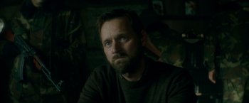 Movie still from “The Hitman's Bodyguard” (2017), directed by Patrick Hughes – A person with a beard looking into the distance; Close Up shot, Over the shoulder angle