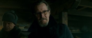 Movie still from “The Hitman's Bodyguard” (2017), directed by Patrick Hughes – A person wearing glasses and a coat; Close Up shot, Low angle