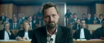 Movie still from “The Hitman's Bodyguard” (2017), directed by Patrick Hughes – A person wearing a suit and tie; Close Up shot, Low angle