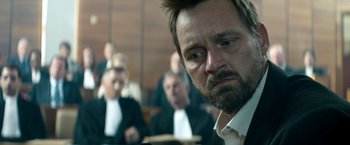 Movie still from “The Hitman's Bodyguard” (2017), directed by Patrick Hughes – A person in a court room; Close Up shot, Over the shoulder angle
