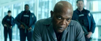 Movie still from “The Hitman's Bodyguard” (2017), directed by Patrick Hughes – An older man with a serious look on his face; Close Up shot, Low angle
