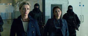 Movie still from “The Hitman's Bodyguard” (2017), directed by Patrick Hughes – A group of people standing next to each other in a room; Medium shot, Over the shoulder angle