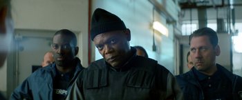 Movie still from “The Hitman's Bodyguard” (2017), directed by Patrick Hughes – A person wearing a jacket and a hat; Close Up shot, Low angle