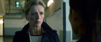 Movie still from “The Hitman's Bodyguard” (2017), directed by Patrick Hughes – A person wearing a jacket near a wall; Close Up shot, Over the shoulder angle