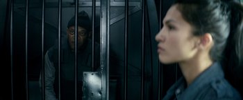 Movie still from “The Hitman's Bodyguard” (2017), directed by Patrick Hughes – A man and a woman behind bars looking at each other; Close Up shot, Low angle