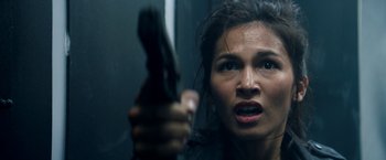 Movie still from “The Hitman's Bodyguard” (2017), directed by Patrick Hughes – A person holding a gun in a room; Close Up shot, Overhead angle