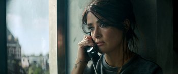 Movie still from “The Hitman's Bodyguard” (2017), directed by Patrick Hughes – A woman is talking on a phone by a window; Close Up shot, High angle