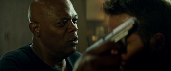 Movie still from “The Hitman's Bodyguard” (2017), directed by Patrick Hughes – A person holding a gun; Close Up shot, Over the shoulder angle
