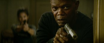 Movie still from “The Hitman's Bodyguard” (2017), directed by Patrick Hughes – A person holding a gun; Close Up shot, Low angle