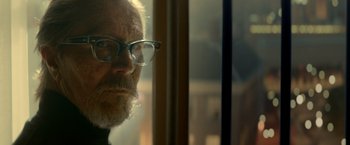 Movie still from “The Hitman's Bodyguard” (2017), directed by Patrick Hughes – An older man with glasses looking out of a window; Close Up shot, Low angle
