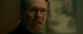 Movie still from “The Hitman's Bodyguard” (2017), directed by Patrick Hughes – An old man with a beard wearing glasses; Close Up shot, Low angle