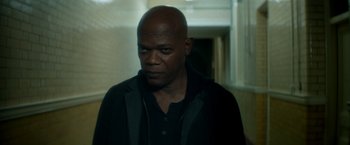 Movie still from “The Hitman's Bodyguard” (2017), directed by Patrick Hughes – A man in a black jacket is looking at the camera; Close Up shot, Low angle