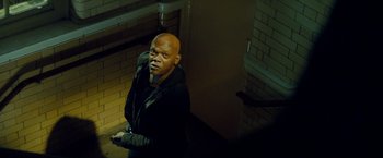Movie still from “The Hitman's Bodyguard” (2017), directed by Patrick Hughes – A man standing on a staircase in a dark room; Medium shot, Low angle