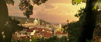 Movie still from “The Hitman's Bodyguard” (2017), directed by Patrick Hughes – A view of a city from a hill with trees in the foreground; Extreme Wide shot, High angle
