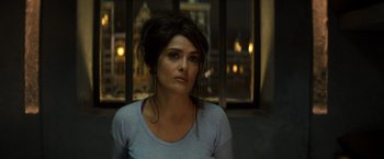 Movie still from “The Hitman's Bodyguard” (2017), directed by Patrick Hughes – A woman in a blue shirt is looking at the camera; Close Up shot, Over the shoulder angle
